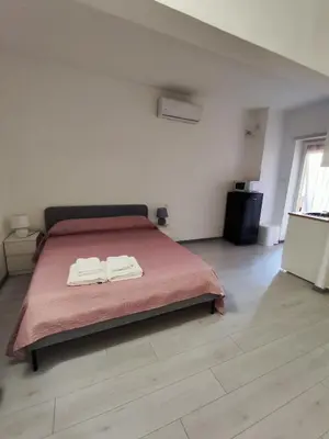 a bedroom with a bed with two towels on it at Trilogy in Trastevere in Rome
