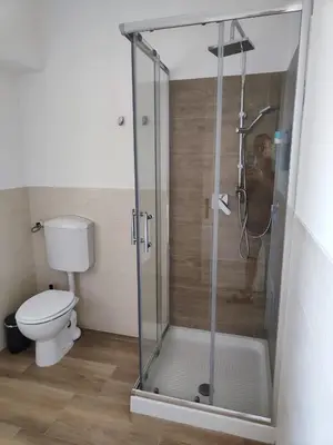 a shower stall in a bathroom with a toilet at Trilogy in Trastevere in Rome