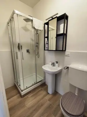 a bathroom with a shower and a toilet and a sink at Trilogy in Trastevere in Rome