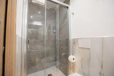 a shower with a glass door in a bathroom at Hotel Maximus in Rome