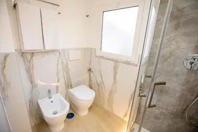 a bathroom with a toilet and a sink and a shower at Hotel Maximus in Rome