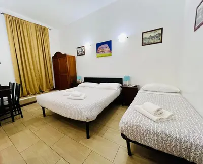 two beds in a hotel room with towels on them at Booking Inn Settembre 95 in Rome