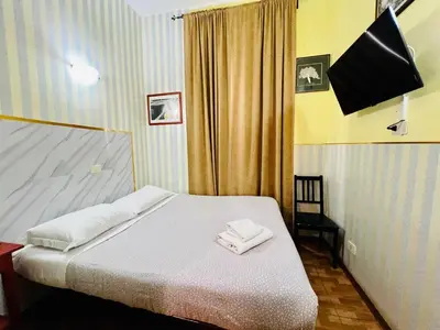 a bedroom with a bed with two towels on it at Booking Inn Settembre 95 in Rome
