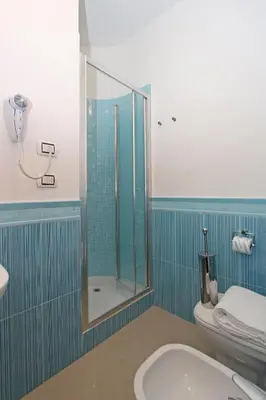 a bathroom with a shower and a toilet and a sink at La Casa Felice a San Pietro in Rome