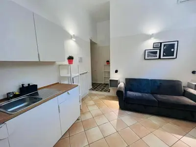 a kitchen and a living room with a couch at Eccelso Suites in Rome