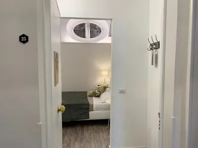 a door leading to a bedroom with a bed at Eccelso Suites in Rome
