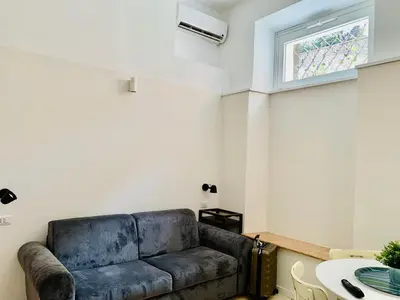 a living room with a couch and a table at Eccelso Suites in Rome