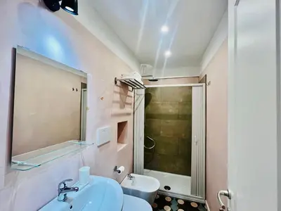 a bathroom with a toilet and a sink and a shower at Eccelso Suites in Rome