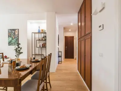 a dining room and living room with a wooden table and chairs at The Best Rent - Apartment in Trastevere area in Rome