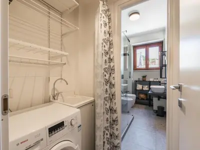 a laundry room with a washer and dryer at The Best Rent - Apartment in Trastevere area in Rome