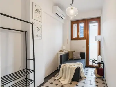 a small room with a bed and a window at The Best Rent - Apartment in Trastevere area in Rome