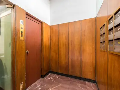 an empty room with wooden walls and doors at The Best Rent - Apartment in Trastevere area in Rome