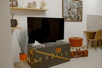 a room with a television and a trunk with a tv on it at Vintage House in Rome