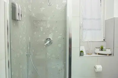 a shower with a glass door in a bathroom at Vintage House in Rome