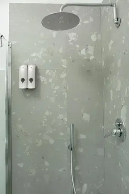 a shower with two rolls of toilet paper on the wall at Vintage House in Rome