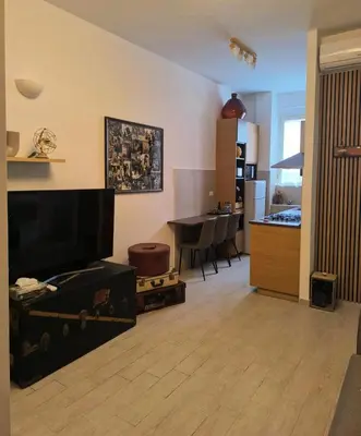 a living room with a television and a dining room at Vintage House in Rome