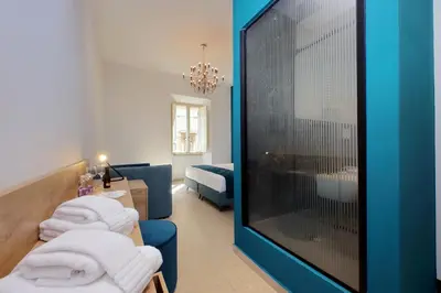 a room with three chairs and a large window at Youroom Quattro Fontane Appartamento in Rome