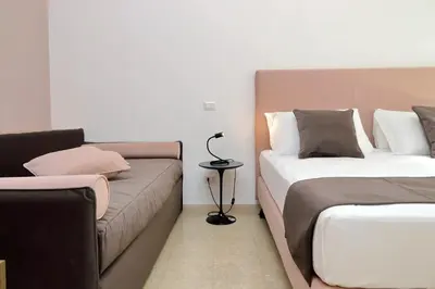 a living room with two beds and a couch at Youroom Quattro Fontane Appartamento in Rome