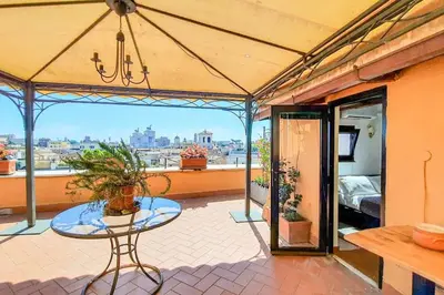 a patio with a table and a view of the city at BrandNew House on the Terrace in Rome