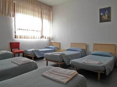 a hospital room with four beds and a window at Casa per Ferie Opera Don Calabria in Rome