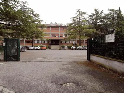 a parking lot in front of a large building at Casa per Ferie Opera Don Calabria in Rome