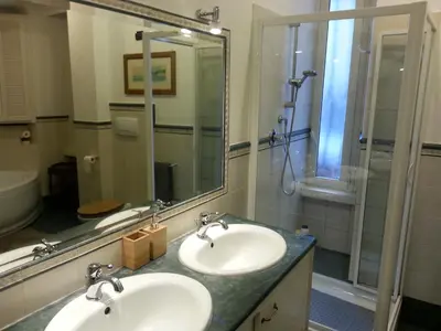 a bathroom with two sinks and a shower at LILIUM HOUSE Apts in Rome