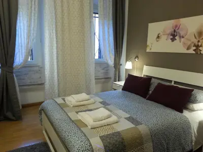 a bedroom with a bed with two towels on it at LILIUM HOUSE Apts in Rome