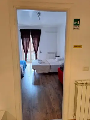 a view of a bedroom with two beds and a window at NASONI DI ROMA (VICINISSIMO BASILICA SAN GIOVANNI IN LATERANO) in Rome