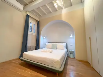a bedroom with a bed in an arched room at [Luxury House & Secret Garden] - Strategic location, 100m to Metro B in Rome