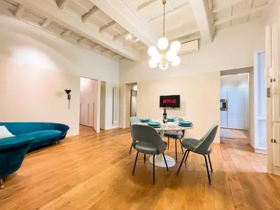 a living room with a table and chairs and a couch at [Luxury House & Secret Garden] - Strategic location, 100m to Metro B in Rome