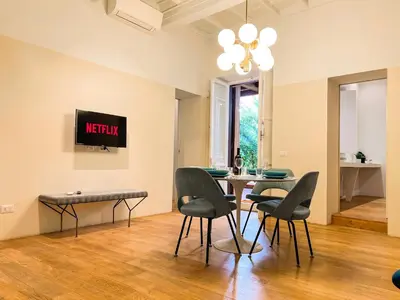 a dining room with a table and chairs at [Luxury House & Secret Garden] - Strategic location, 100m to Metro B in Rome