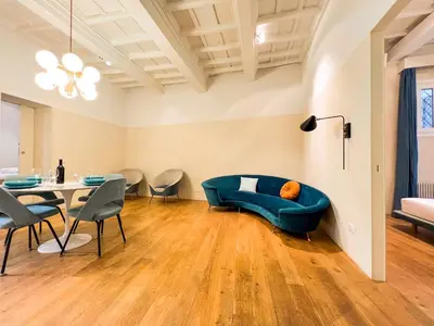 a living room with a blue couch and a table at [Luxury House & Secret Garden] - Strategic location, 100m to Metro B in Rome