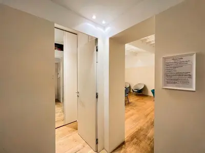 a hallway with a mirror and a door in a room at [Luxury House & Secret Garden] - Strategic location, 100m to Metro B in Rome