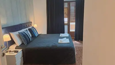 a bedroom with a bed with a pair of shoes on it at IN ROMA LIFE in Rome