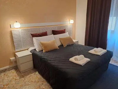 a bedroom with a large bed with two towels on it at IN ROMA LIFE in Rome
