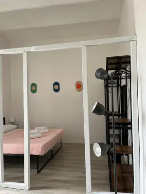 a bedroom with a bed with a pink mattress at Colosseo Living Suites in Rome