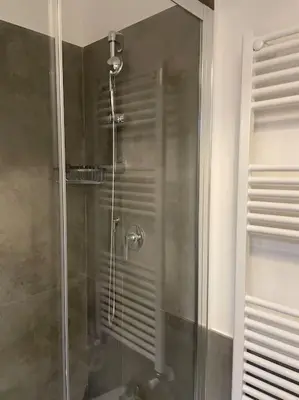 a shower with a glass door in a bathroom at Colosseo Living Suites in Rome