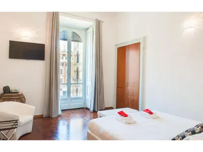 a hotel room with a bed and a window at Lh Royal Suites Terrace in Rome