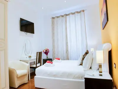 a white room with a bed and a chair at Lh Royal Suites Terrace in Rome