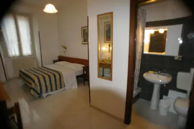a hotel room with a bed and a sink at Le Rose di Bi in Rome