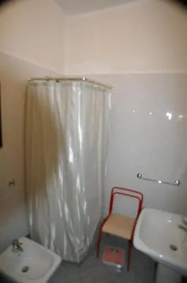 a bathroom with a white shower curtain and a sink at Le Rose di Bi in Rome