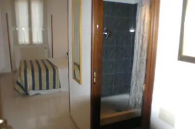 a door to a bedroom with a bed in a room at Le Rose di Bi in Rome