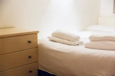 two towels are stacked on a bed in a bedroom at La dolce Silla - Appartamenti al Vaticano,Via Silla 91 in Rome