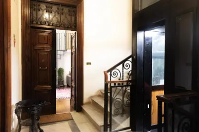 a hallway with a staircase leading to a door at La dolce Silla - Appartamenti al Vaticano,Via Silla 91 in Rome