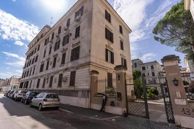a building with cars parked on the side of a street at Lovely flat in Testaccio in Rome