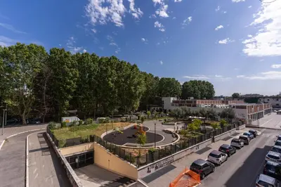 a building with a park in the middle of a street at Lovely flat in Testaccio in Rome