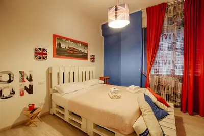 a bedroom with a bed and a red curtain at Jet Lag Guesthouse in Rome