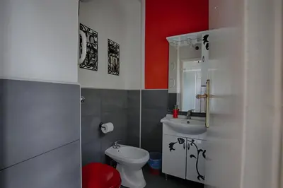 a bathroom with a white toilet and a sink at Jet Lag Guesthouse in Rome