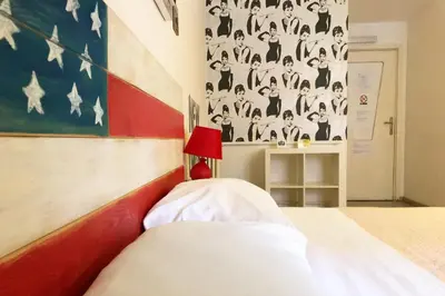 a bedroom with a bed and a painting on the wall at Jet Lag Guesthouse in Rome