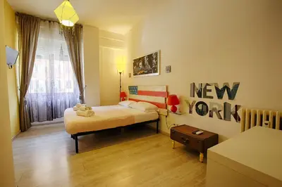 a bedroom with a bed and a nework sign on the wall at Jet Lag Guesthouse in Rome